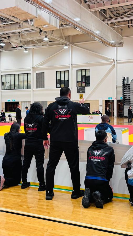 Respect Judo Club coaches courtside at a competition