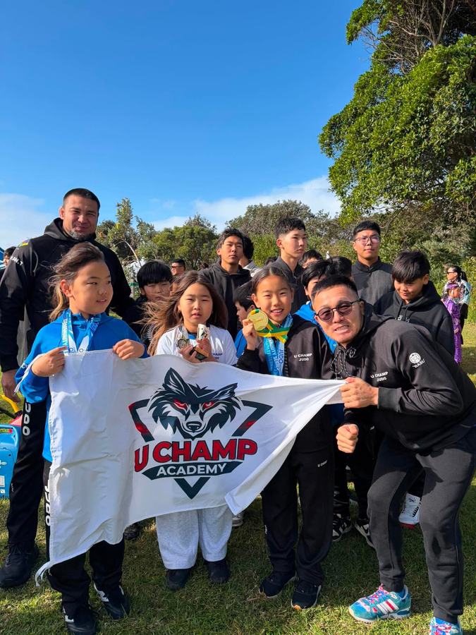 Respect Judo Club team holding the club flag