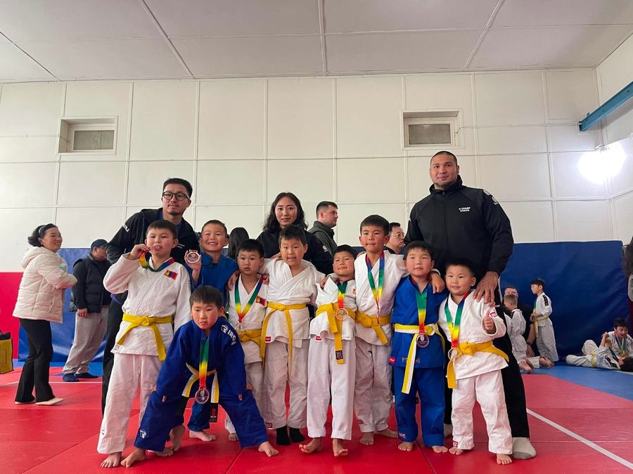 Respect Judo Club students with coaches and medals