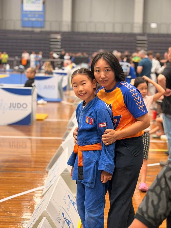 Parent and daughter at a judo competition