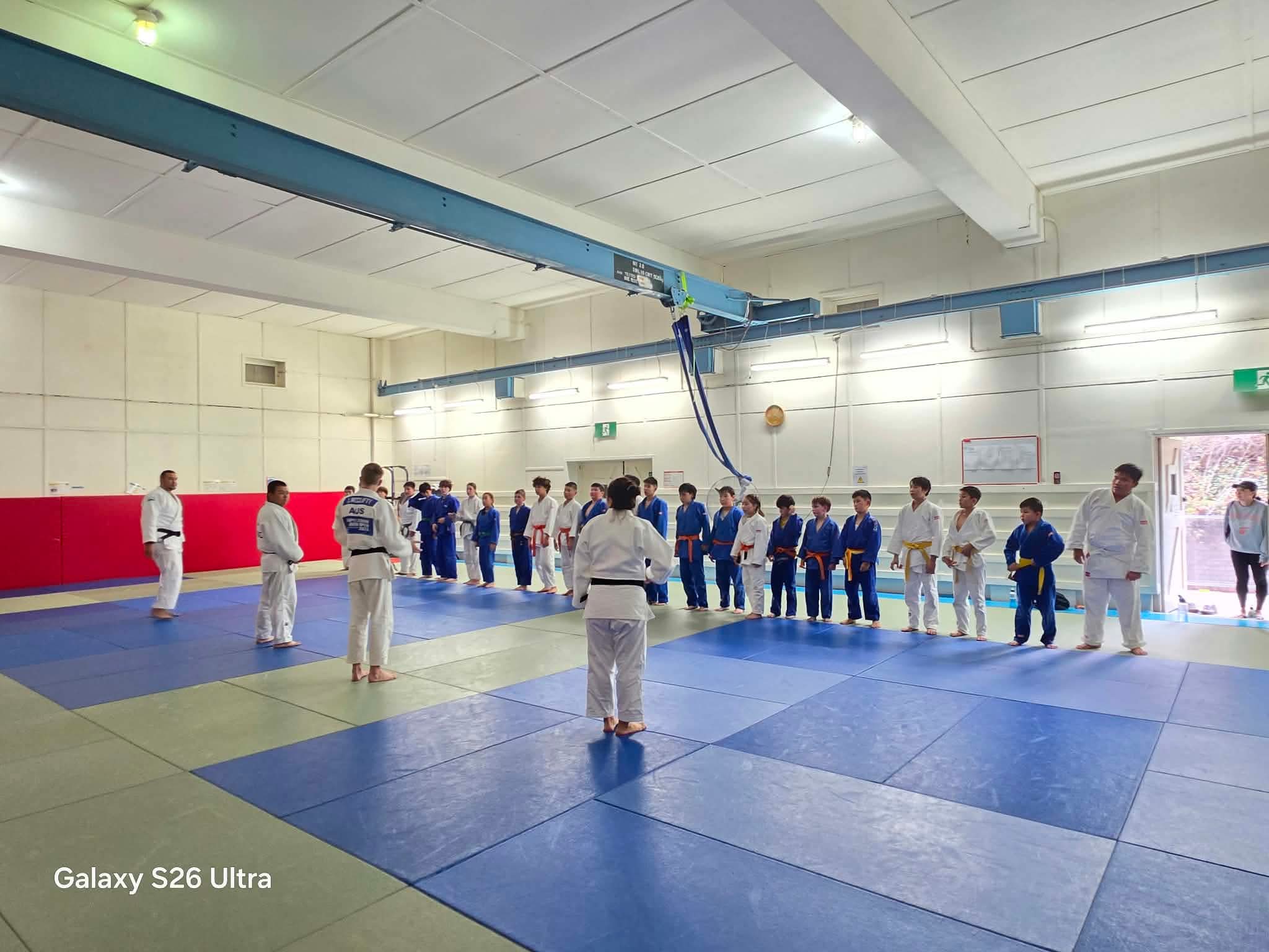 Judo students and coaches during dojo training