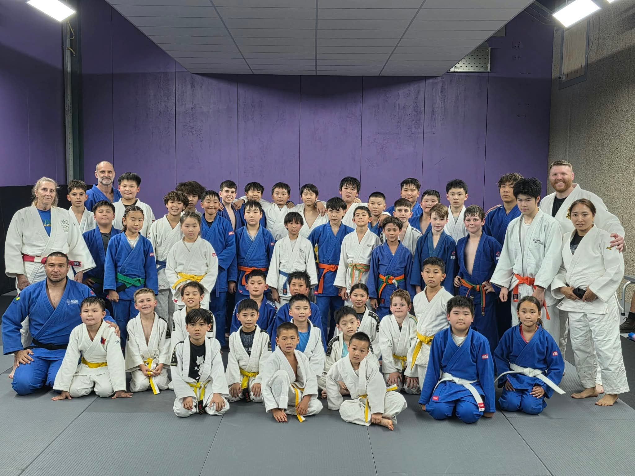 Junior judo students with visiting coaches